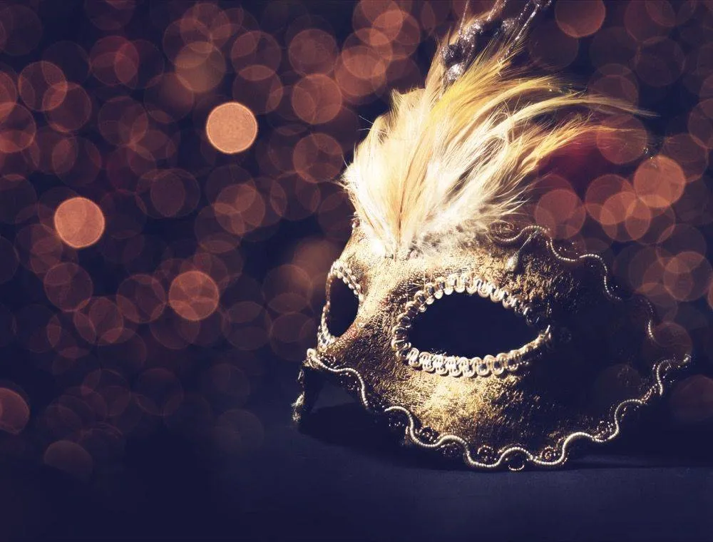 Ornate masquerade mask with warm bokeh lighting